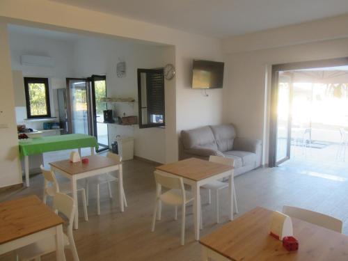 a living room with tables and a couch at Il Sogno di Calipso in Amendolara