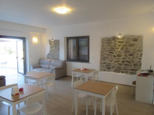 a living room with tables and a couch at Il Sogno di Calipso in Amendolara