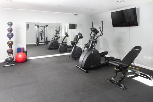 a gym with several exercise bikes and a flat screen tv at Red Lion Inn & Suites Sequim at Olympic National Park in Sequim