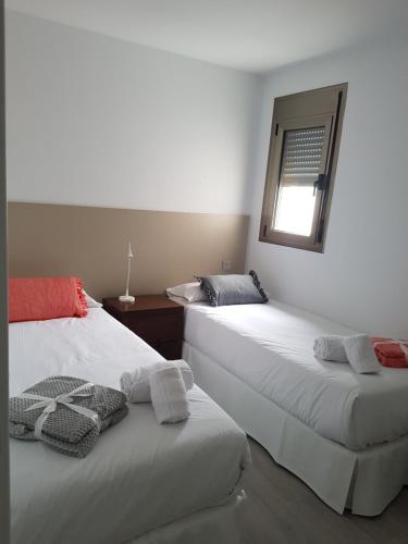 two beds sitting next to each other in a room at RK City Center in Las Palmas de Gran Canaria