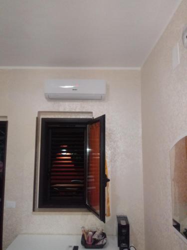 a bathroom with a window with a heater in it at Anema e Core Pizzo in Pizzo