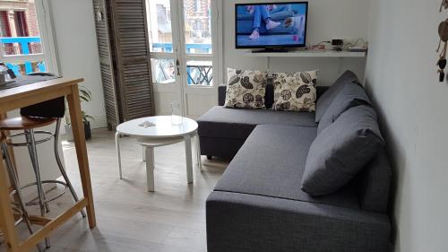 a living room with a couch and a table at 100 m de la mer, Sauna, Wifi in Mers-les-Bains