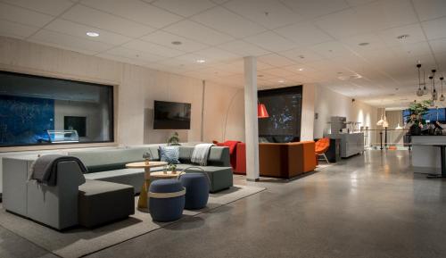 a living room with couches and tables in a room at RS Noatun in Horten