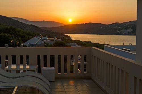 a view of the sunset from a balcony at Villa Serenity in Porto Rafti