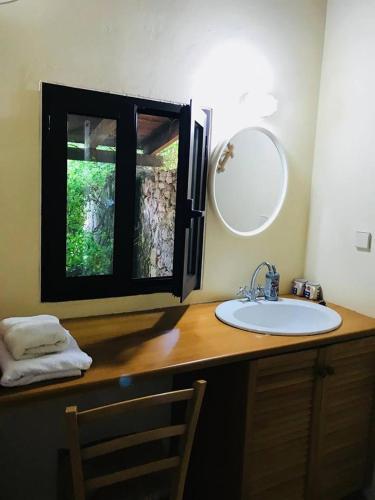 a bathroom with a sink and a mirror on a counter at Gentilini Retreat in Argostoli