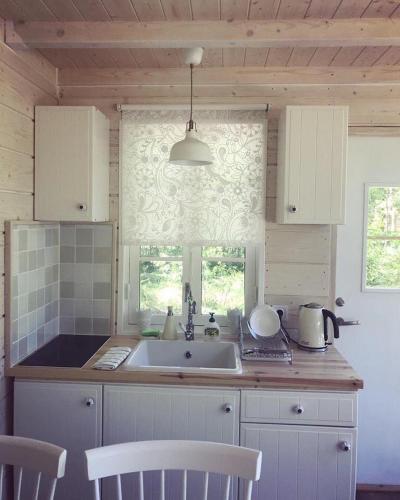 a kitchen with a sink and a window at Tahkuna Forest House in Kõrgessaare