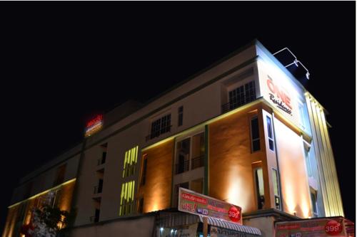 a building with neon lights on the side of it at The One Residence in Udon Thani