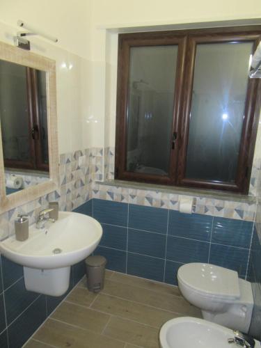 a bathroom with a sink and a toilet at Il Sogno di Calipso in Amendolara
