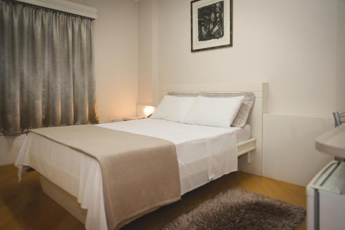 Tempat tidur dalam kamar di Hotel Pallis