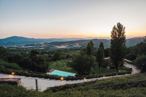 a view of a villa with a pool and trees at Nikis Resort in Gubbio