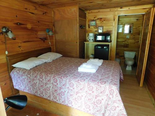 a bedroom with a bed in a cabin at Pine Crest Motel & Cabins in Barton