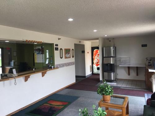 a lobby of a restaurant with a counter and a refrigerator at Prairie Rose inn in Edgeley