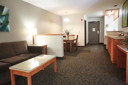 a living room with a couch and a table at Radisson Hotel Portland Airport in Portland