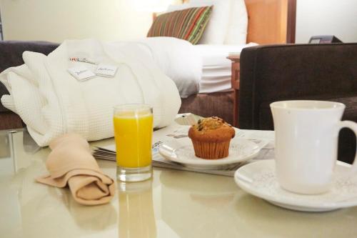 a table with a cupcake and a glass of orange juice at Radisson Hotel Portland Airport in Portland