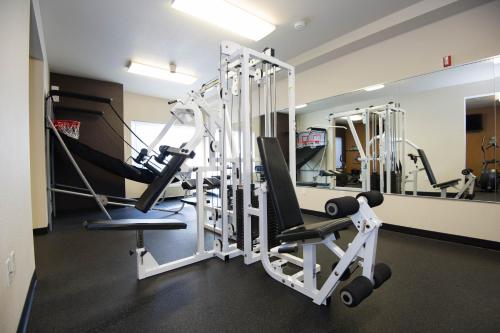 a gym with several tread machines in a room at Radisson Hotel Portland Airport in Portland