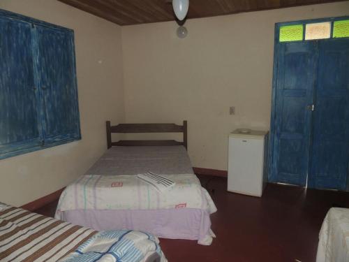 מיטה או מיטות בחדר ב-Pousada Sitio da Serra
