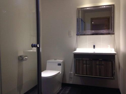 a bathroom with a toilet and a sink at Ski-in, Ski-out Iwatake Apartments in Hakuba