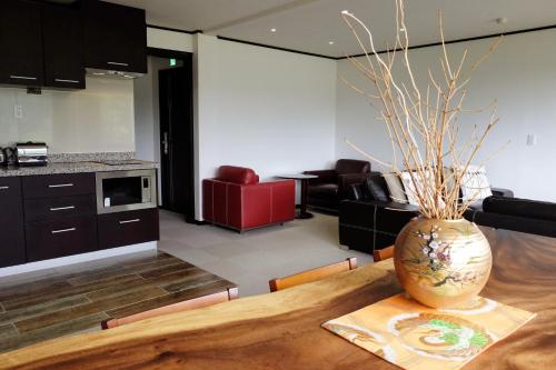a vase sitting on a table in a kitchen at Ski-in, Ski-out Iwatake Apartments in Hakuba