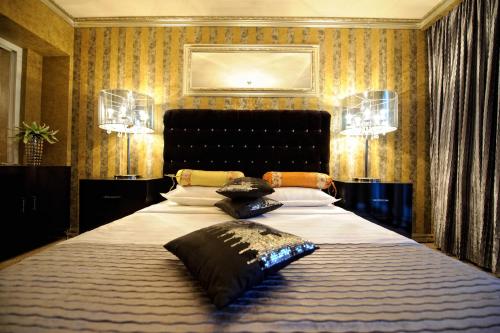 Un dormitorio con una cama grande con almohadas. en Portobella Boutique SELF CHECK IN, en Mamaia Nord – Năvodari