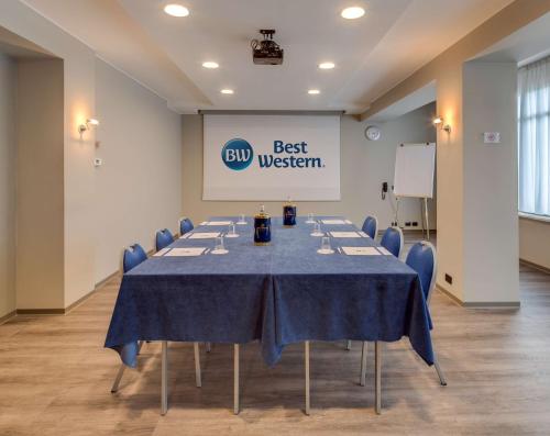 a meeting room with a long table with blue table cloth at Best Western Hotel Turismo in San Martino Buon Albergo