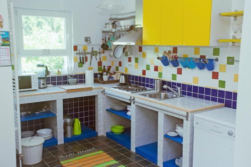 a toy kitchen with a sink and a counter at Riverview apartment Three Springs Tri Zvira in Zamost