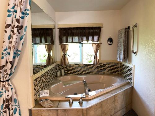 a large tub in a bathroom with a window at Wheeler on the Bay Lodge and Marina in Wheeler