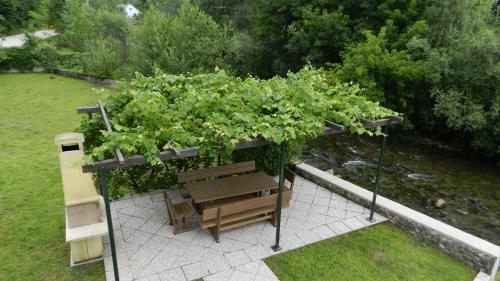a pergola with a plant on top of a bench at Riverview apartment Three Springs Tri Zvira in Zamost