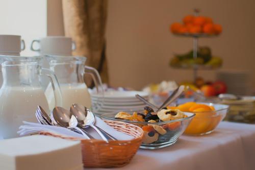 a table with a plate of food and a bowl of milk at Memel Hotel in Klaipėda
