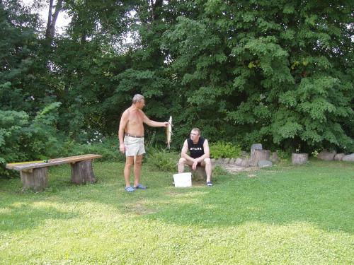 a man standing next to a woman in a park at Villa River Rose in Jõesuu