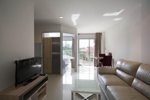 a living room with a couch and a flat screen tv at Mosaic Condominium A34M by malai in Ban Bua Phut