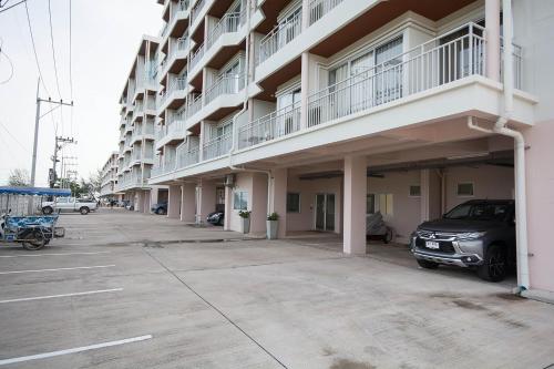 an empty parking lot in front of a building at Mosaic Condominium A34M by malai in Ban Bua Phut