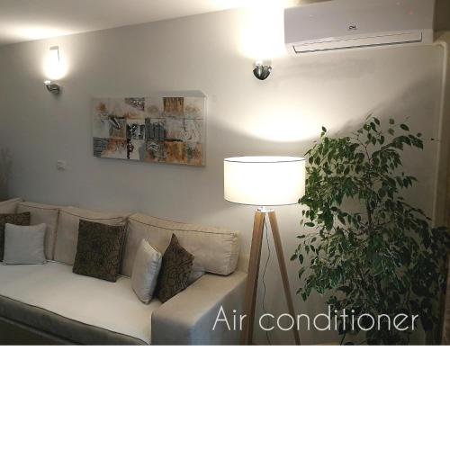 a living room with a couch and a lamp at Apartment Andy in Medvode