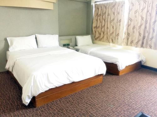 Una cama o camas en una habitación de K.S.Pavilion Hotel