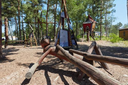 a playground with a swing set and a slide at Tropical Islands in Krausnick