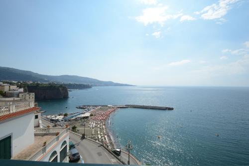 a view of a beach with a pier in the water at Panorama Palace Hotel in Meta