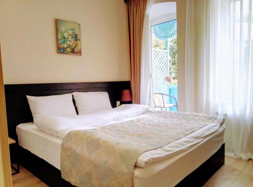 a bedroom with a large bed and a window at Old Town Mtatsminda in Tbilisi City