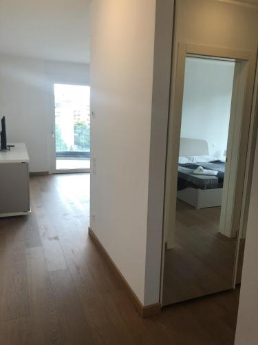 a room with a mirror and a bedroom with a bed at Roggia Apartments by Quokka 360 - central flats with parking space in Lugano
