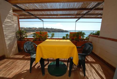 a dining room table with chairs and umbrellas at Hotel Baia Del Sorriso in Castiglioncello