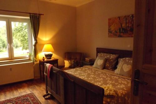 a bedroom with a bed and a window at Studniska Country Estate in Studniska