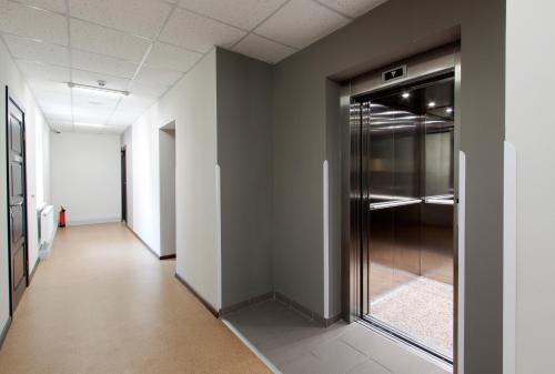 an empty hallway with a glass door in a building at Hotel Dolynskiy in Lviv