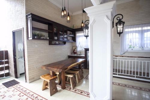 a kitchen with a wooden table in a room at Huis Van Gustafine Floor 2 in Malang