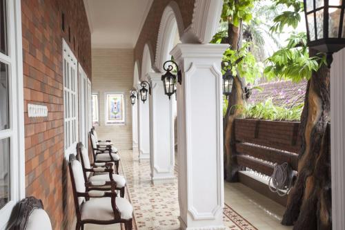 a row of chairs sitting in a hallway with a window at Huis Van Gustafine Floor 2 in Malang
