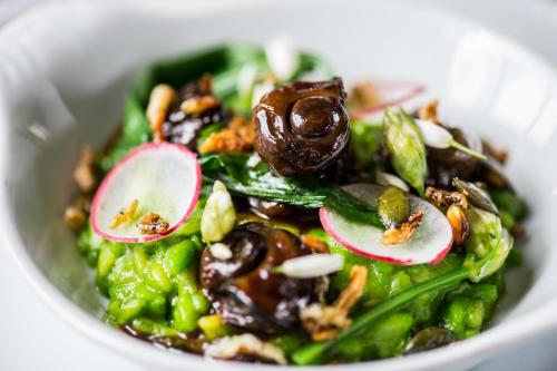 a white bowl filled with a salad with vegetables at Hart's Hotel in Nottingham
