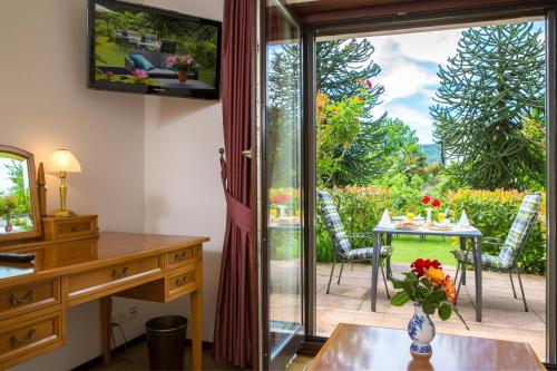 a living room with a sliding glass door leading to a patio at Hotel Al Fiume in Tegna