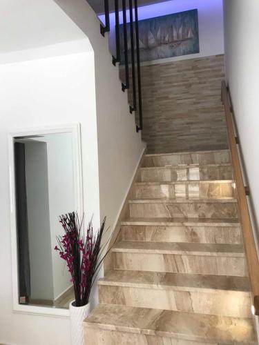 a staircase with a mirror and a vase with flowers at Villa Radić in Ston