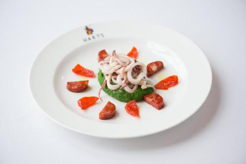 a plate of food with strawberries on a white plate at Hart's Hotel in Nottingham