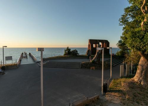 a group of stairs with the ocean in the background at Apartamenty Klifowa z widokiem na morze in Trzęsacz