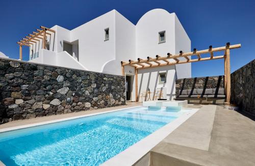 a villa with a swimming pool and a house at Altera Pars Suites in Mesaria