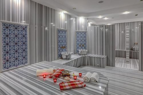 a room with a bed with red candles on it at Merit Grand Mosta Spa Hotel & Casino in Svilengrad