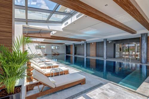 an indoor swimming pool with a resort style house with a swimming poolvisor at Merit Grand Mosta Spa Hotel & Casino in Svilengrad